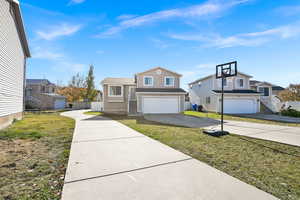 View of front facade with a front yard and a garage