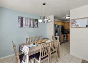 Tiled dining area with a chandelier