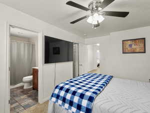 Master bedroom with connected bathroom, and ceiling fan