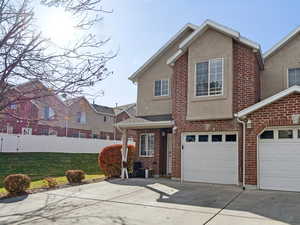 View of front facade featuring a large side yard and a garage