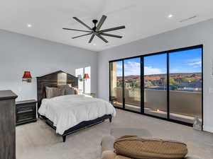 Bedroom featuring access to exterior, a mountain view, light colored carpet, and ceiling fan