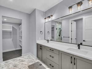 Bathroom featuring vanity and an enclosed shower