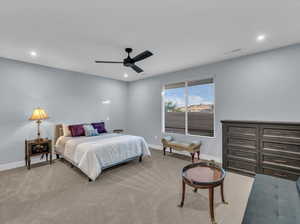 Carpeted bedroom with ceiling fan