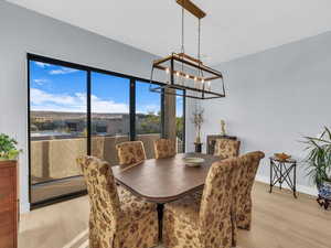 Dining space with a notable chandelier and light wood-type flooring