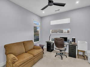 Carpeted office space with ceiling fan