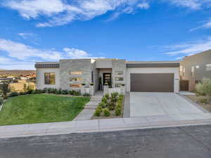 Contemporary house featuring a front lawn and a garage