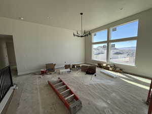 Unfurnished dining area featuring an inviting chandelier and baseboards