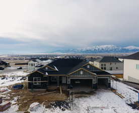 View of front of property featuring a garage and a mountain view