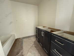 Bathroom featuring a bath and vanity