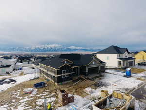 Snowy aerial view featuring a mountain view