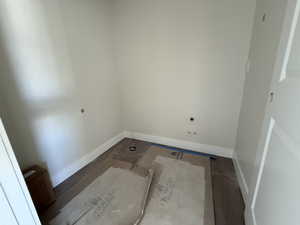 Clothes washing area with baseboards