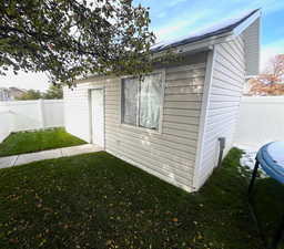 View of outdoor structure with a yard and a trampoline