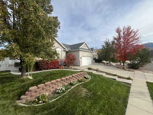 View of front of home featuring a garage and a front lawn