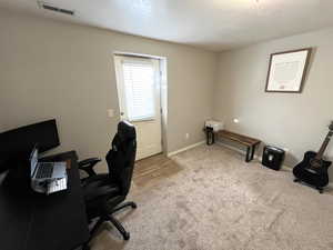 Office area featuring a textured ceiling and light hardwood / wood-style flooring