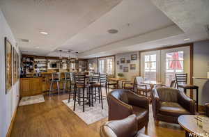 Dining area with a wealth of natural light, hardwood / wood-style floors, and a textured ceiling