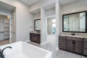 Bathroom with vanity and separate shower and tub