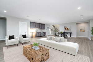 Living room with light wood-type flooring and sink