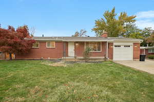 Ranch-style house with a front lawn and a garage