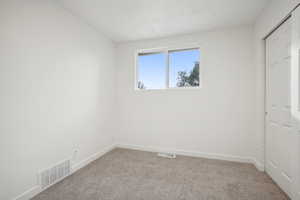 Unfurnished bedroom with carpet floors and a closet