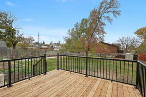 Wooden terrace with a lawn and a storage unit