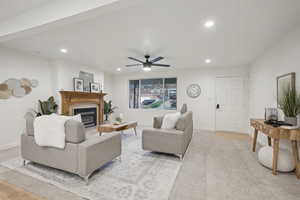 Living room with ceiling fan and light hardwood / wood-style flooring