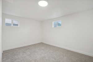 Basement featuring carpet and plenty of natural light