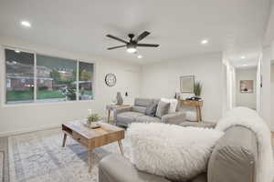 Living room featuring light carpet and ceiling fan