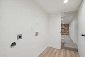 Laundry room featuring hookup for an electric dryer, washer hookup, and light hardwood / wood-style floors