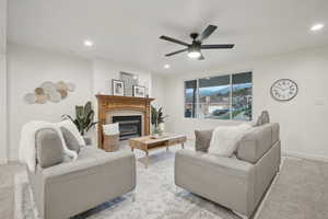 Carpeted living room with ceiling fan