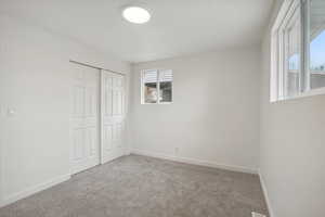 Unfurnished bedroom with carpet floors and a closet