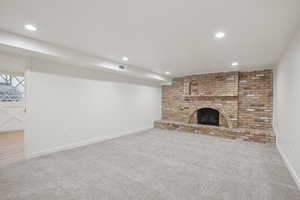 Unfurnished living room featuring carpet and a fireplace