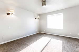 Spare room featuring ceiling fan and carpet floors