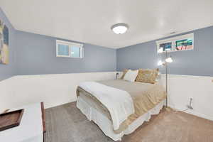 Carpeted bedroom featuring a textured ceiling