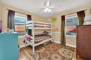 Bedroom featuring ceiling fan and light hardwood / wood-style flooring