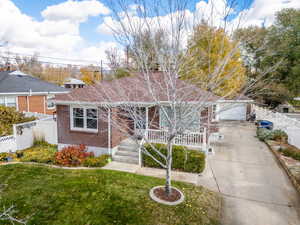 View of front of house with a garage and a front lawn