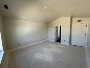 Additional living space featuring lofted ceiling and baseboards