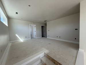 Empty room with visible vents and baseboards