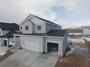 View of front of home featuring a garage and a mountain view