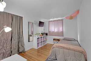 Bedroom with light hardwood / wood-style flooring