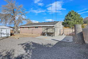 Rear view of house featuring a patio and a storage shed