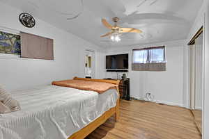 Bedroom featuring ceiling fan and light hardwood / wood-style floors