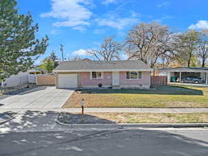 View of front of property featuring a front yard and a garage