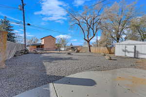 View of yard featuring a shed and a patio area