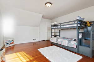 Bedroom with dark wood-type flooring