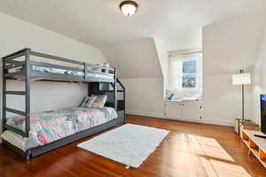 Bedroom featuring hardwood / wood-style floors and vaulted ceiling