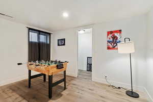 Game room with light wood-type flooring