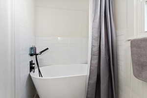 Remodeled Bathroom featuring NEW Tile and soaking tub