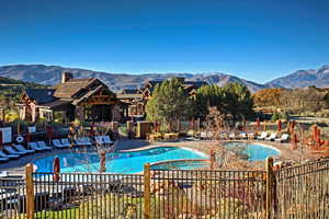 View of swimming pool featuring a mountain view and a hot tub