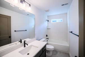 Full bathroom featuring wood-type flooring, vanity, toilet, and tiled shower / bath