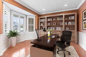 Office space featuring light hardwood / wood-style floors and crown molding